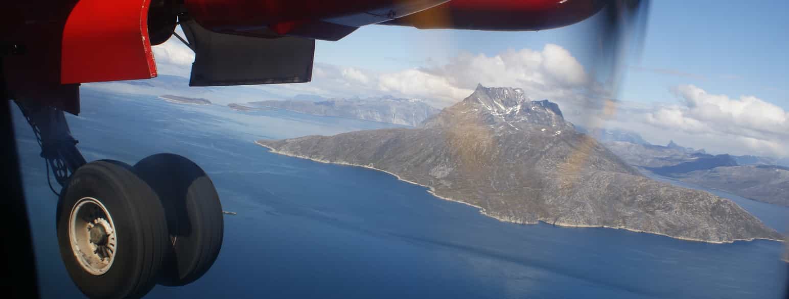 Fly på vei inn for landing ved Nuuk lufthavn på Grønland. Fjellet Sermitsiaq i bakgrunnen