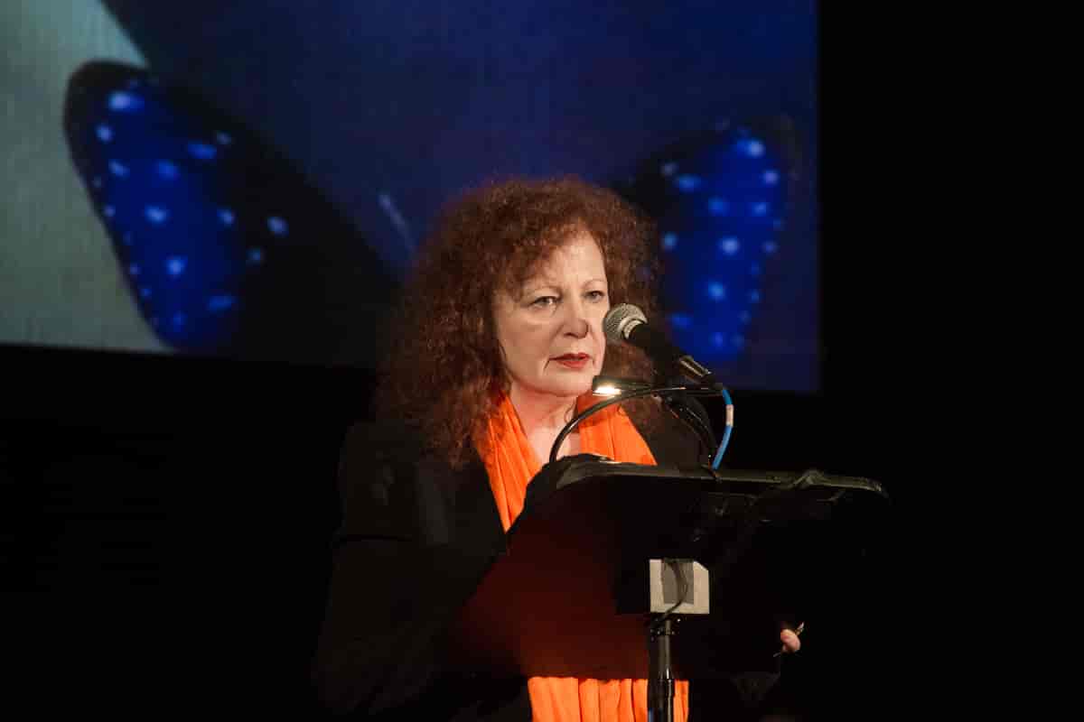 Nan Goldin reads during the official commemoration of the International Day to End Violence against Women.