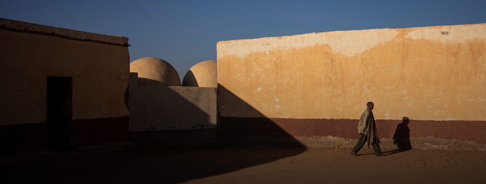 En mann går forbi en stengt skole i Bir Lahlou i Vest-Sahara høsten 2021.