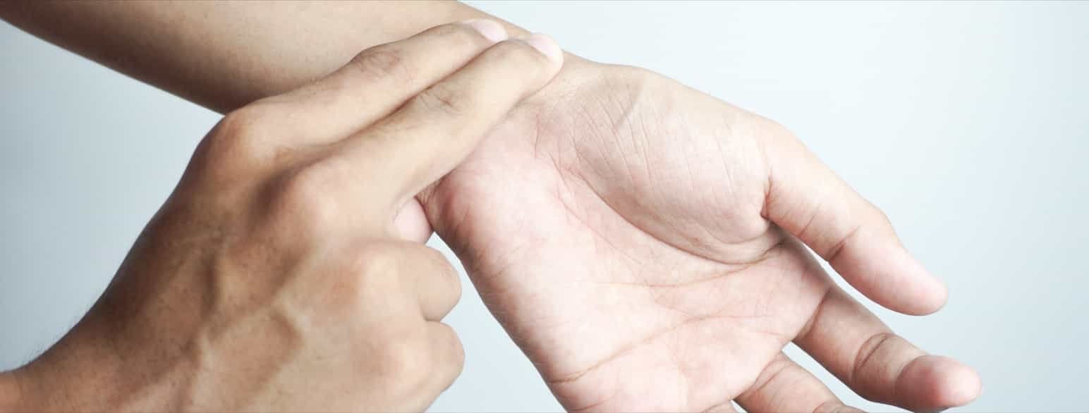 To fingre holdes over arterien på tommelfingersiden av håndleddet. 