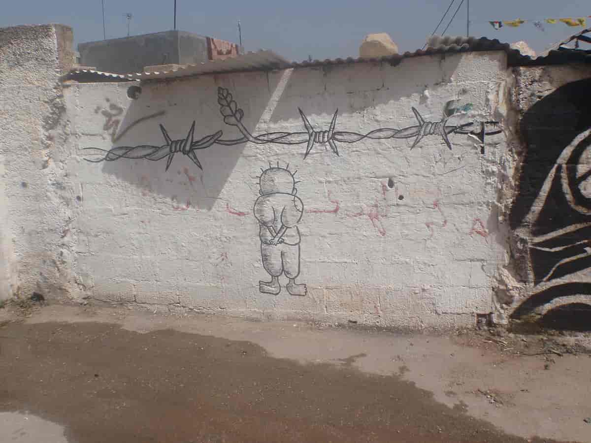 Graffiti med Handala som motiv i den palestinske landsbyen Bilin