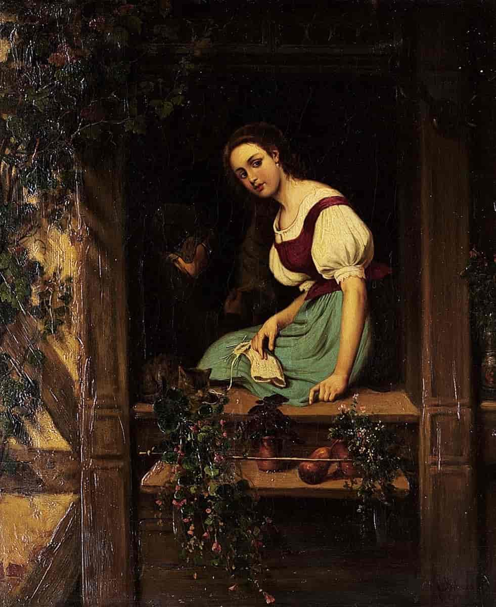  Ung kvinne i vindu med strikketøy og katt
