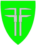 Kommunevåpenet til Flesberg har to tømmerklaver i sølv på grønn bunn